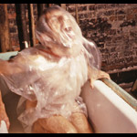 Man wrapped in clear plastic screaming in bathtub