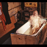 Man wrapped in clear plastic choking in bathtub